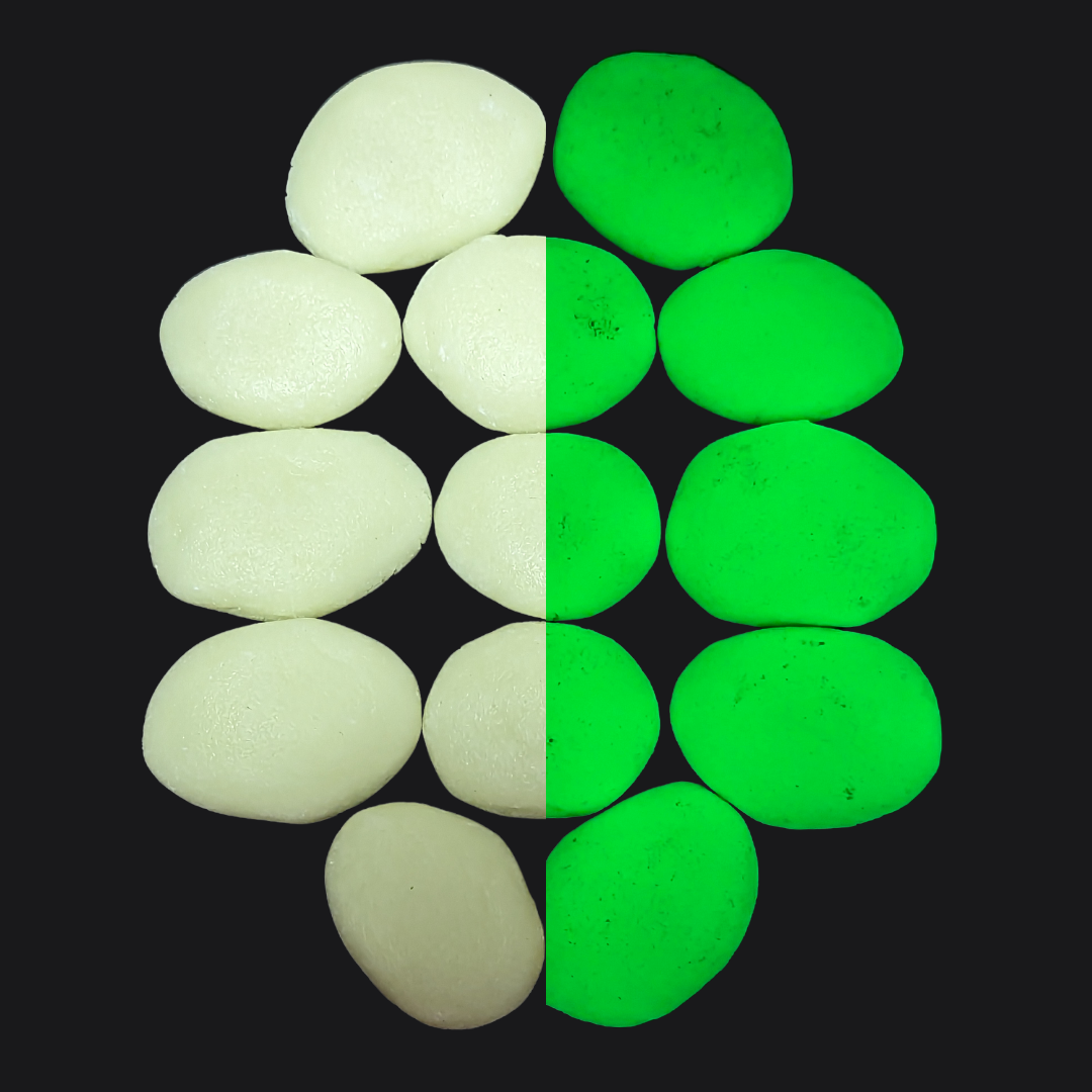 Close-up of It Glows glow-in-the-dark stones, emitting a soft blue-green light.