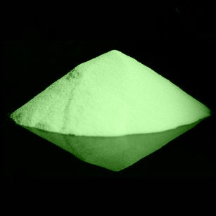 Nighttime view of glow-in-the-dark powder, brightly illuminated in a soft green hue.